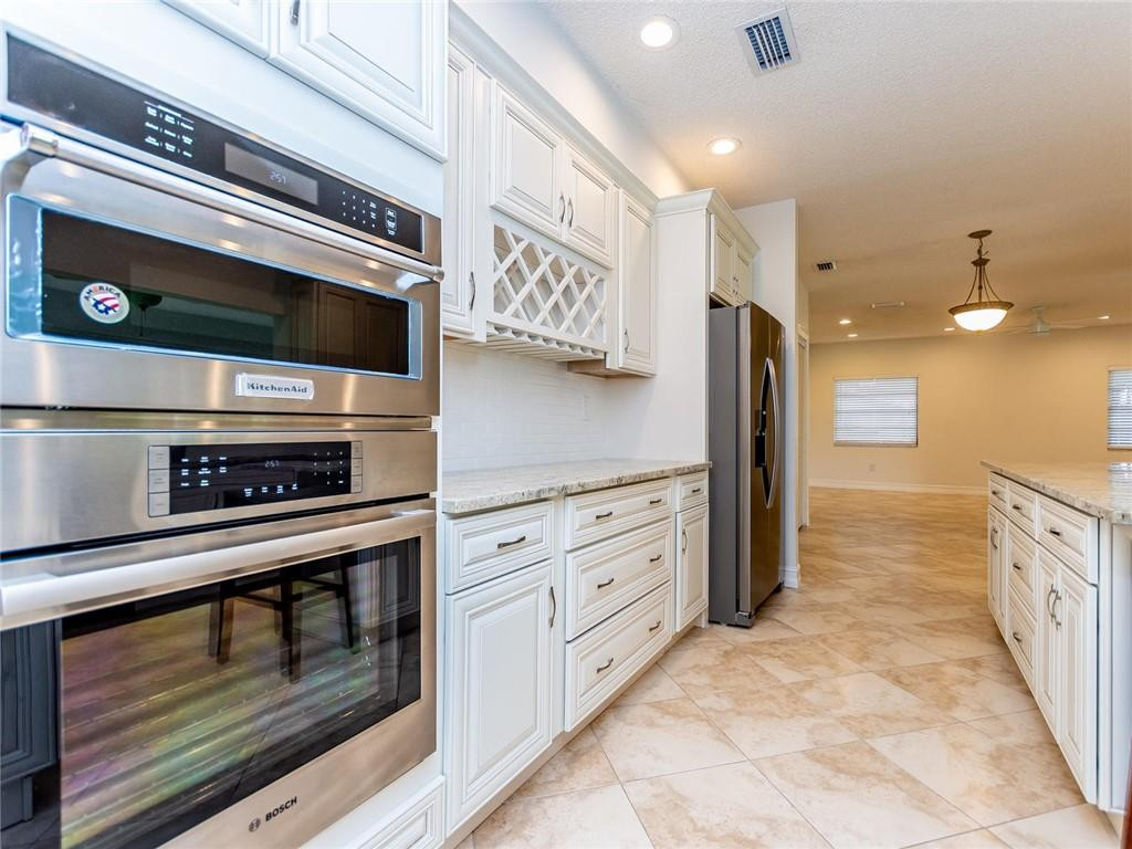5520 Southwest 166th Avenue Southwest Ranches, FL 33331 - Photo 16 of 50 a kitchen with stainless steel appliances kitchen island wooden cabinets and granite counter tops