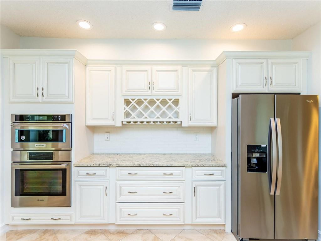 5520 Southwest 166th Avenue Southwest Ranches, FL 33331 - Photo 17 of 50 a kitchen with granite countertop white cabinets and stainless steel appliances