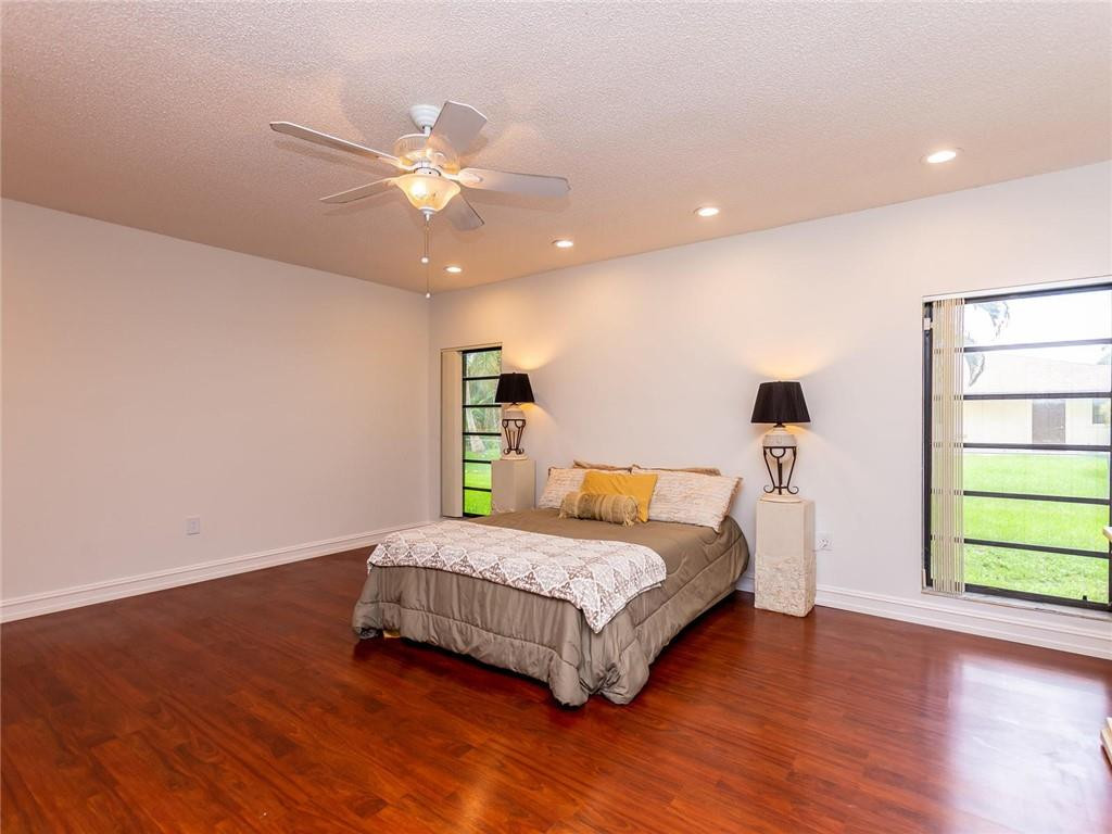 5520 Southwest 166th Avenue Southwest Ranches, FL 33331 - Photo 23 of 50 a bedroom with a bed and a chandelier