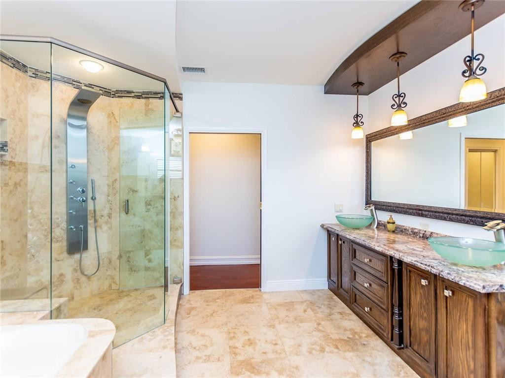 5520 Southwest 166th Avenue Southwest Ranches, FL 33331 - Photo 25 of 50 a bathroom with a granite countertop sink mirror and shower