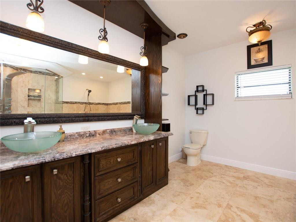 5520 Southwest 166th Avenue Southwest Ranches, FL 33331 - Photo 27 of 50 a bathroom with a granite countertop sink mirror and toilet