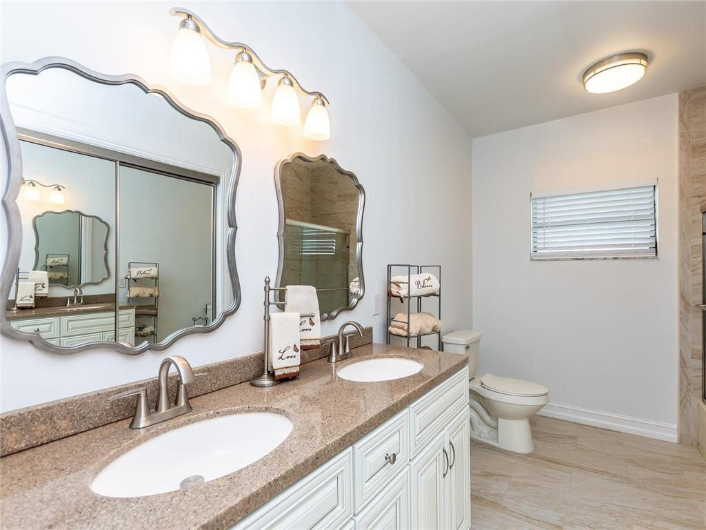 5520 Southwest 166th Avenue Southwest Ranches, FL 33331 - Photo 30 of 50 a bathroom with a granite countertop sink a large mirror and a toilet