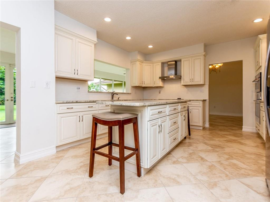 5520 Southwest 166th Avenue Southwest Ranches, FL 33331 - Photo 8 of 50 a kitchen with stainless steel appliances granite countertop a stove a sink dishwasher a refrigerator and white cabinets with wooden floor
