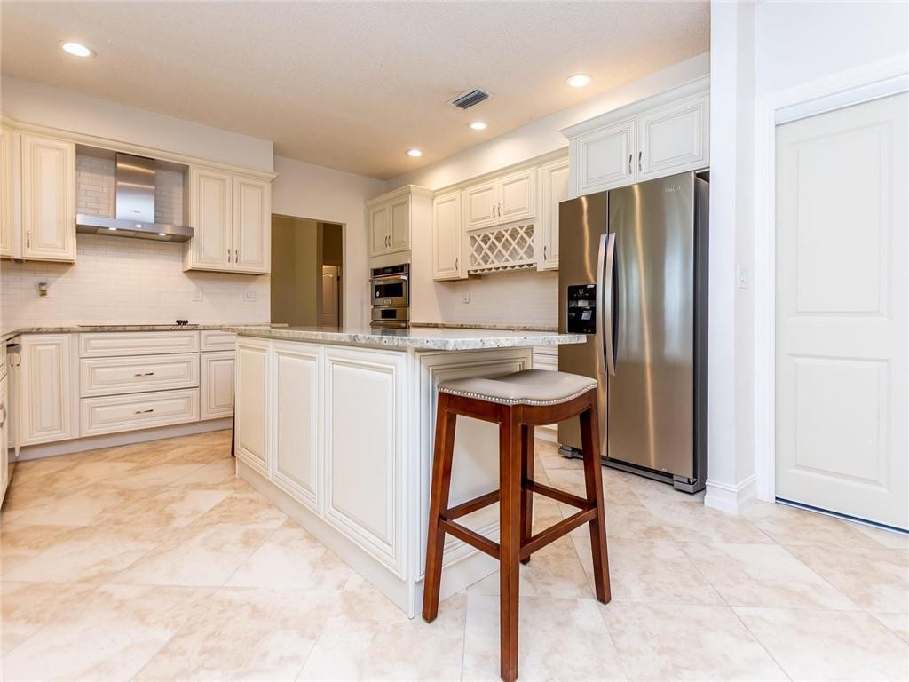 5520 Southwest 166th Avenue Southwest Ranches, FL 33331 - Photo 9 of 50 a kitchen with stainless steel appliances a refrigerator sink and cabinets