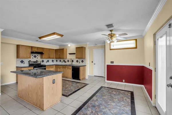 a kitchen with stainless steel appliances granite countertop a sink and a stove