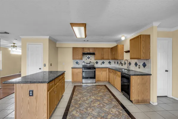 a kitchen with stainless steel appliances granite countertop a stove and a sink
