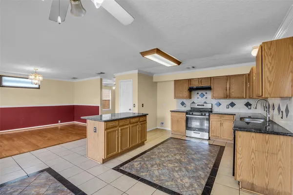 a large kitchen with cabinets and wooden floor