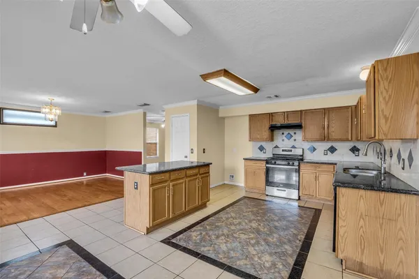 a large kitchen with cabinets and wooden floor