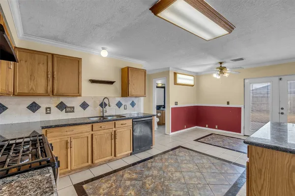 a kitchen with stainless steel appliances granite countertop a sink and cabinets