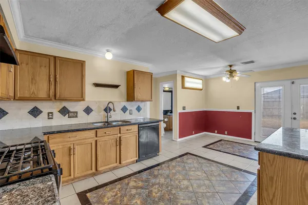 a kitchen with stainless steel appliances granite countertop a sink and cabinets