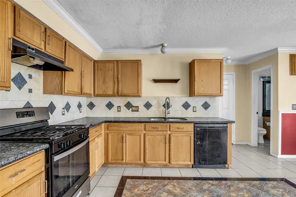 a kitchen with stainless steel appliances granite countertop a sink stove and cabinets