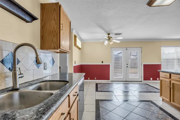a kitchen with a sink cabinets and window
