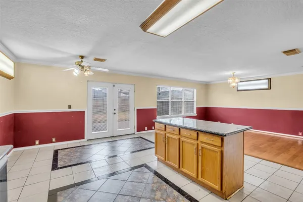 a view of kitchen with microwave and cabinets