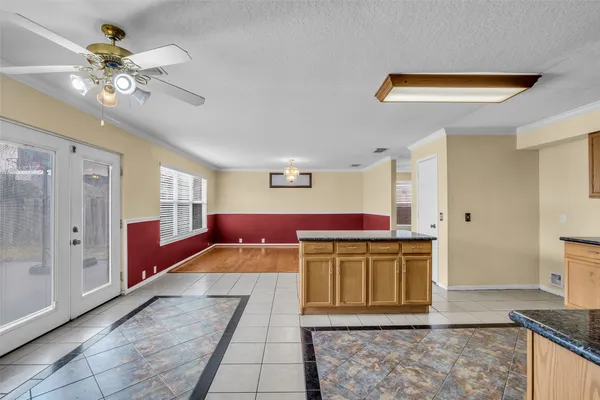 a kitchen with a stove a refrigerator and chandelier