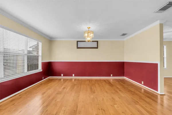 a view of a room with wooden floor and a window