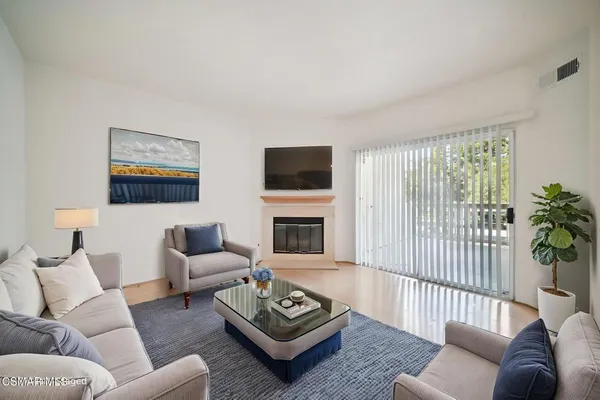 a living room with furniture a couch and a flat screen tv