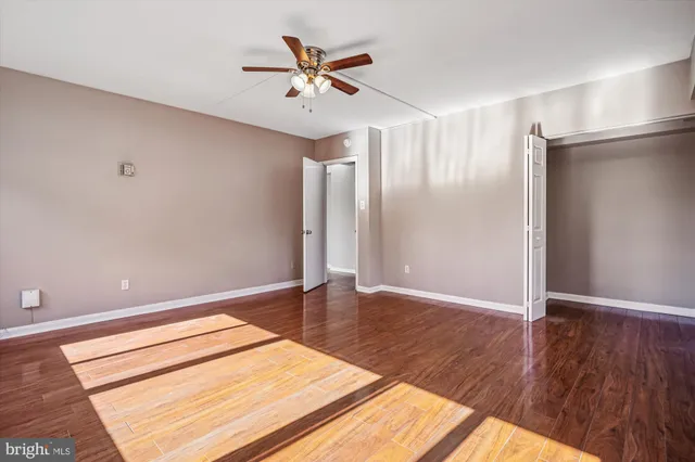 a view of walk in closet with wooden floor