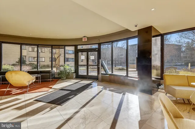 a dining room with furniture and a floor to ceiling window