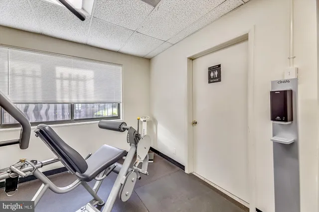 a view of a kitchen with fridge and wooden floor