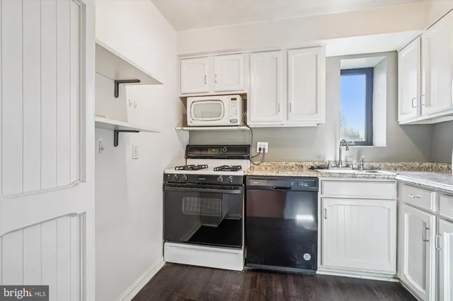 a kitchen with cabinets appliances and a sink