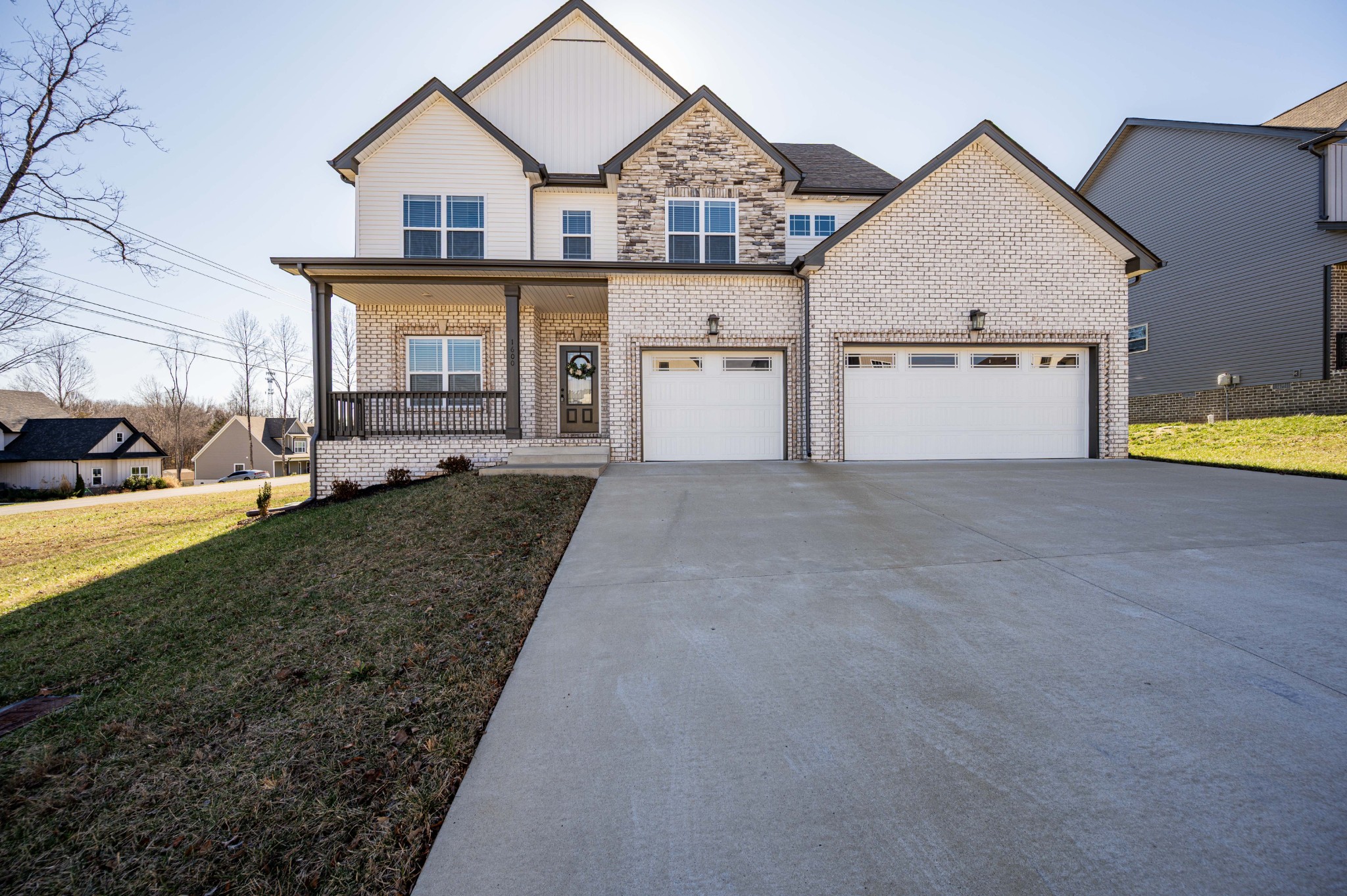 1600 Malone Way Clarksville, TN 37043 - Photo 1 of 39 a view of a white house next to a yard with plants and large trees