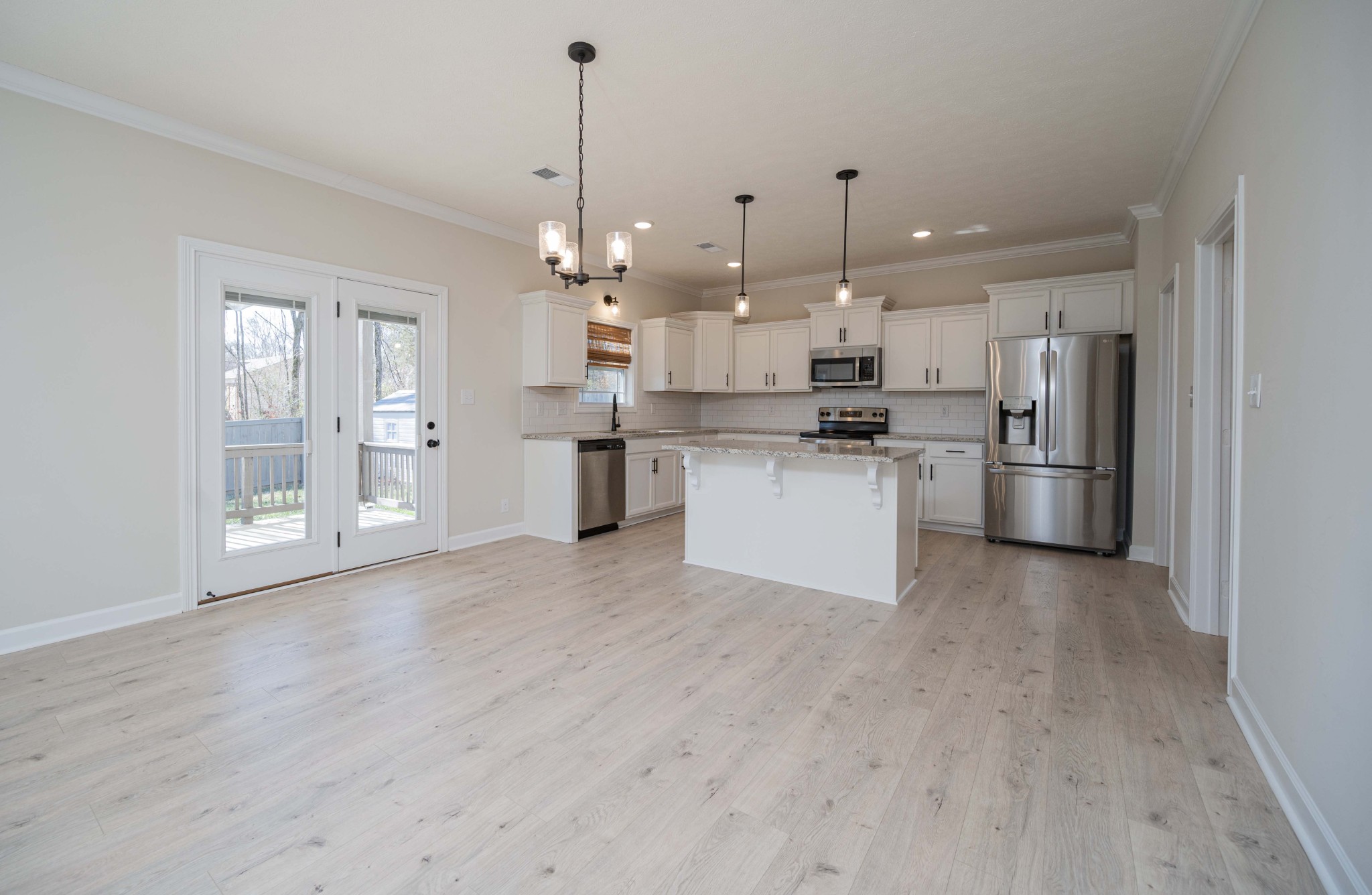 1600 Malone Way Clarksville, TN 37043 - Photo 12 of 39 a open kitchen with stainless steel appliances granite countertop a refrigerator a oven a sink dishwasher and white cabinets with wooden floor