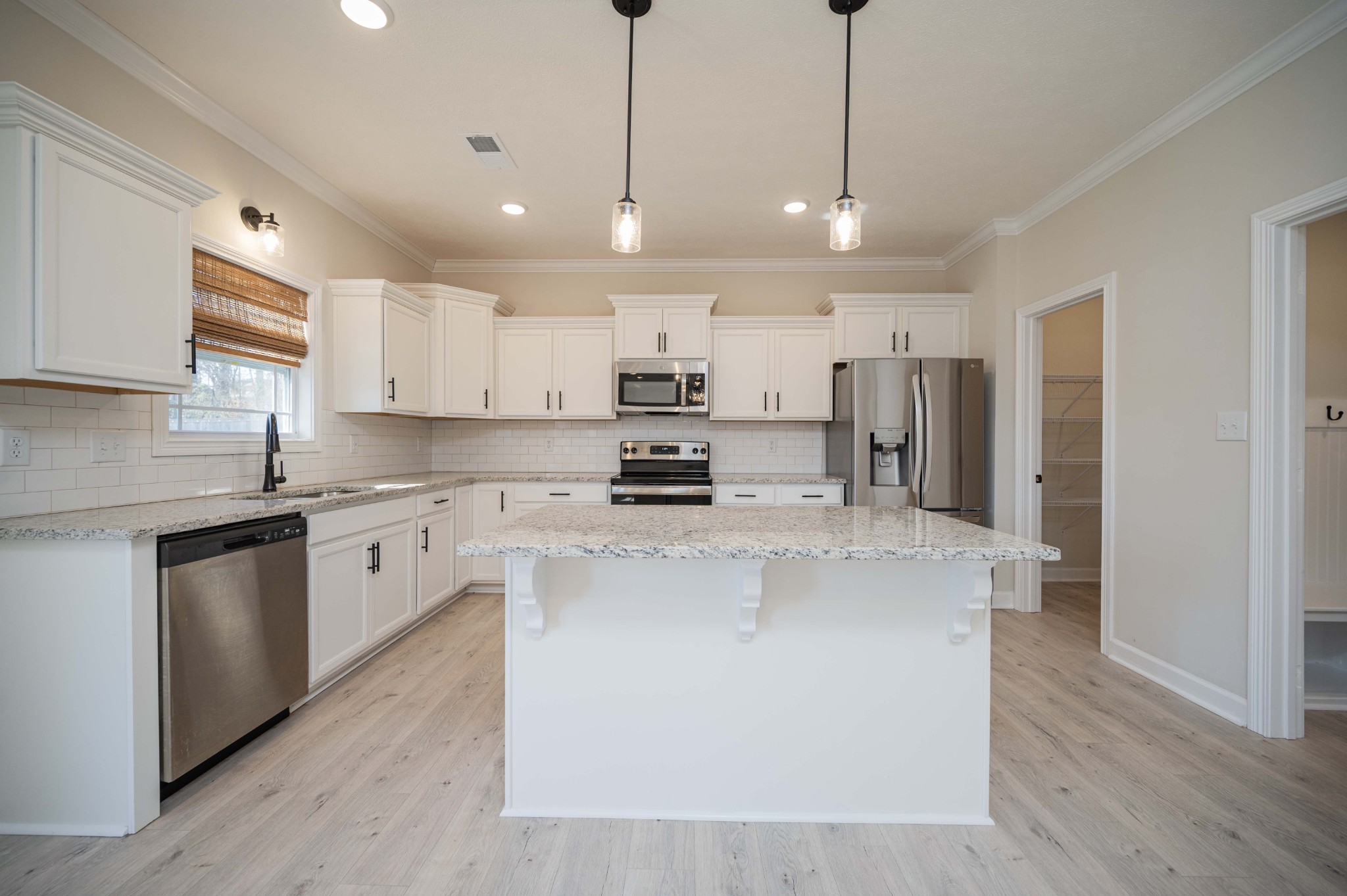 1600 Malone Way Clarksville, TN 37043 - Photo 15 of 39 a kitchen with stainless steel appliances granite countertop a sink a stove a refrigerator and island with wooden floor