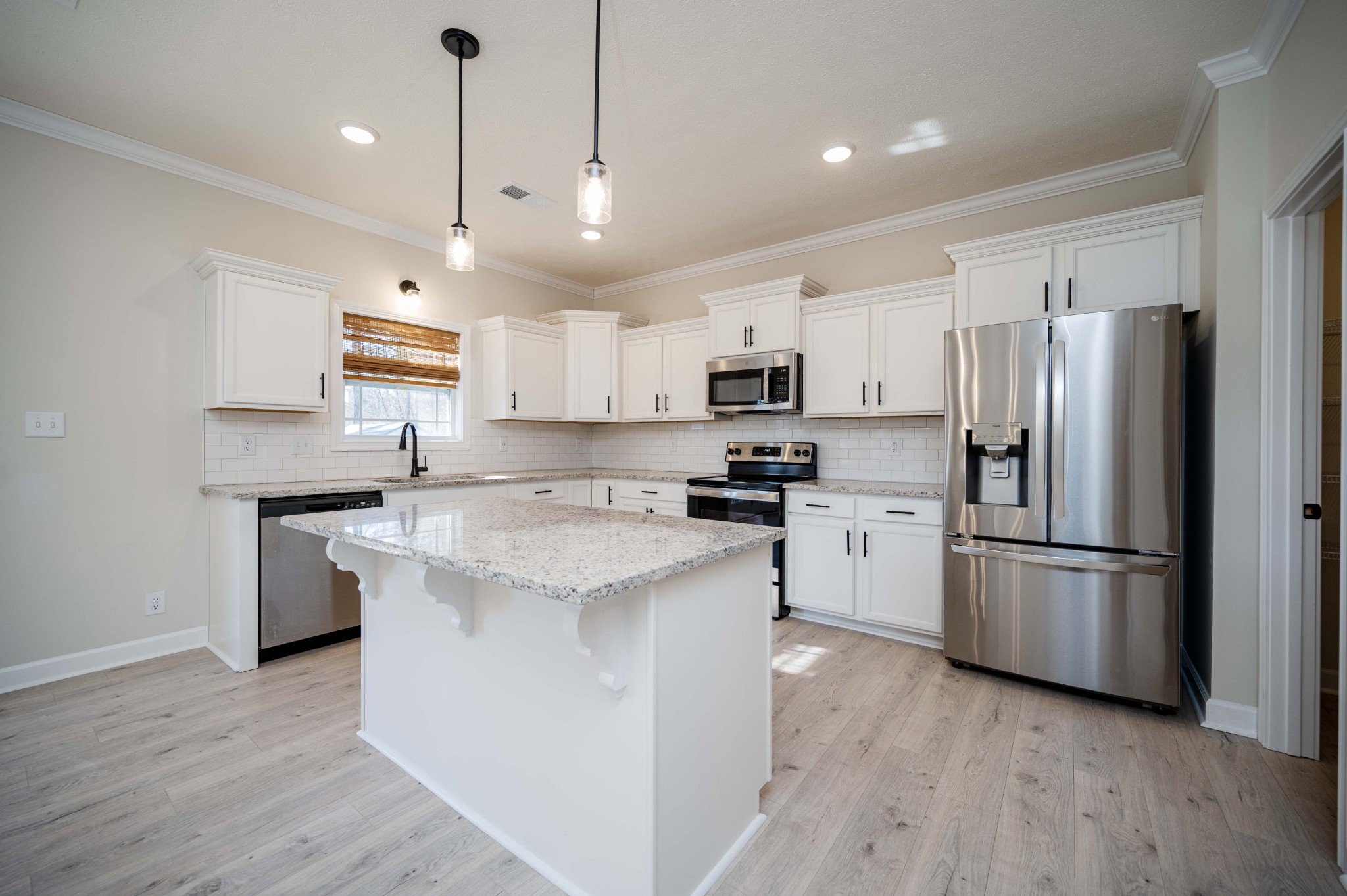 1600 Malone Way Clarksville, TN 37043 - Photo 16 of 39 a kitchen with kitchen island white cabinets and stainless steel appliances