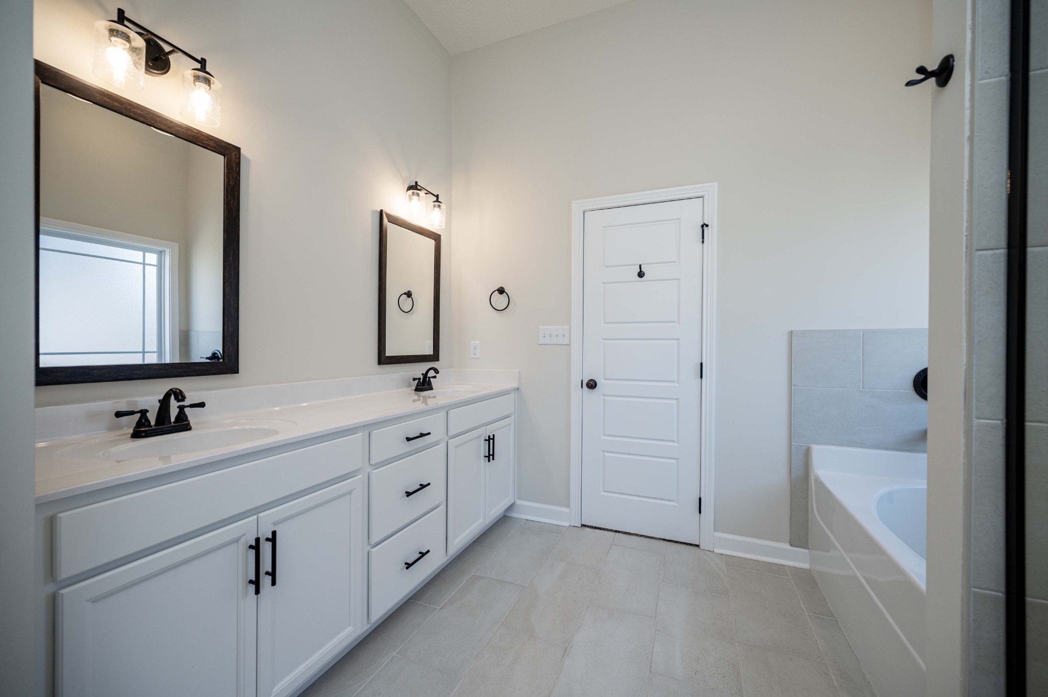 1600 Malone Way Clarksville, TN 37043 - Photo 26 of 39 a bathroom with a double vanity sink and mirror with shower