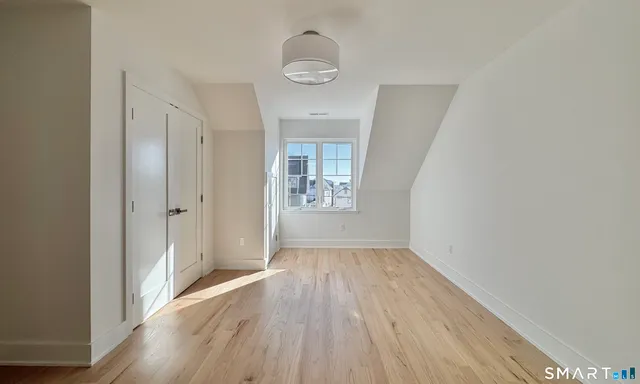 a bathroom with a granite countertop toilet a sink a mirror and shower