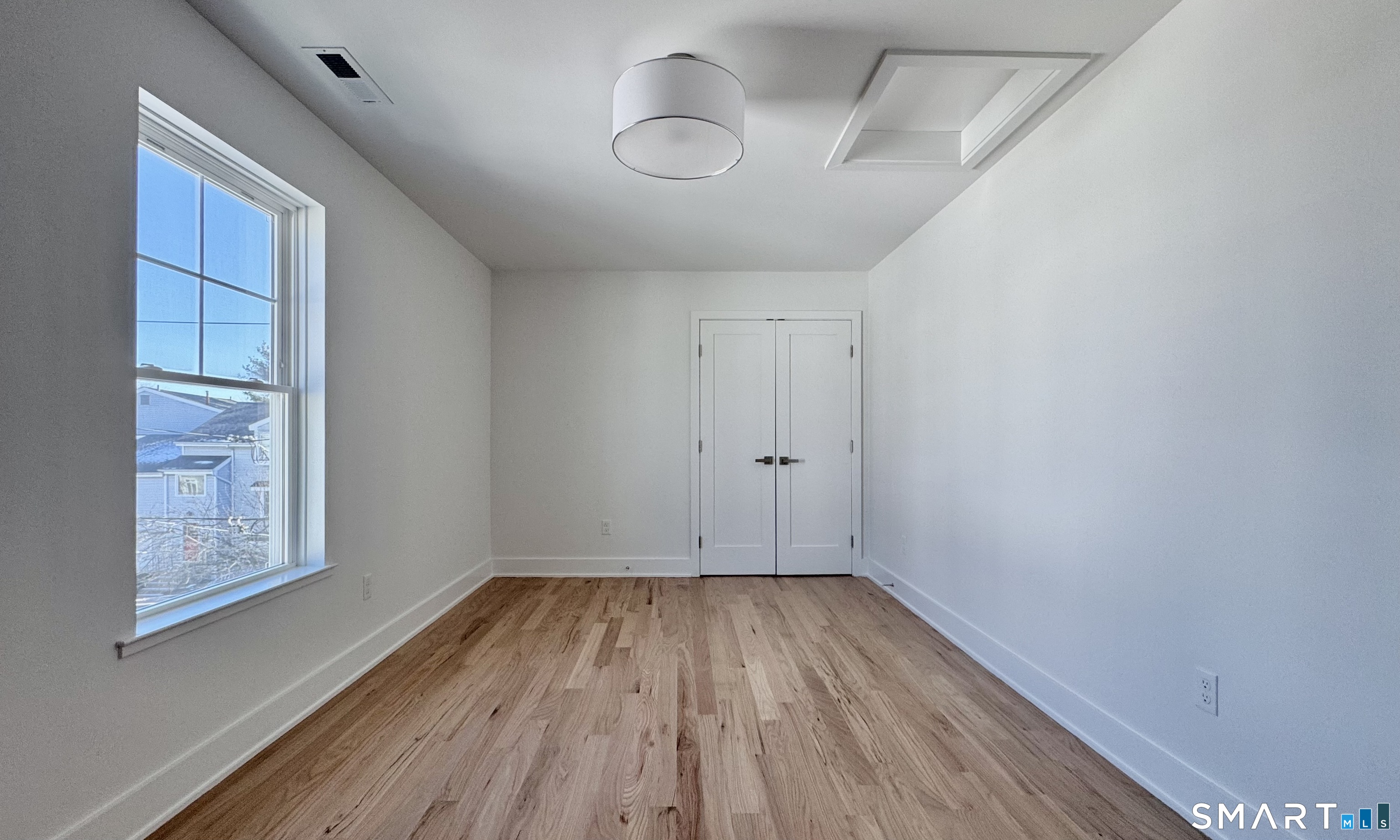 25 Village Road Milford, CT 06460 - Photo 16 of 27 a view of empty room with wooden floor and fan