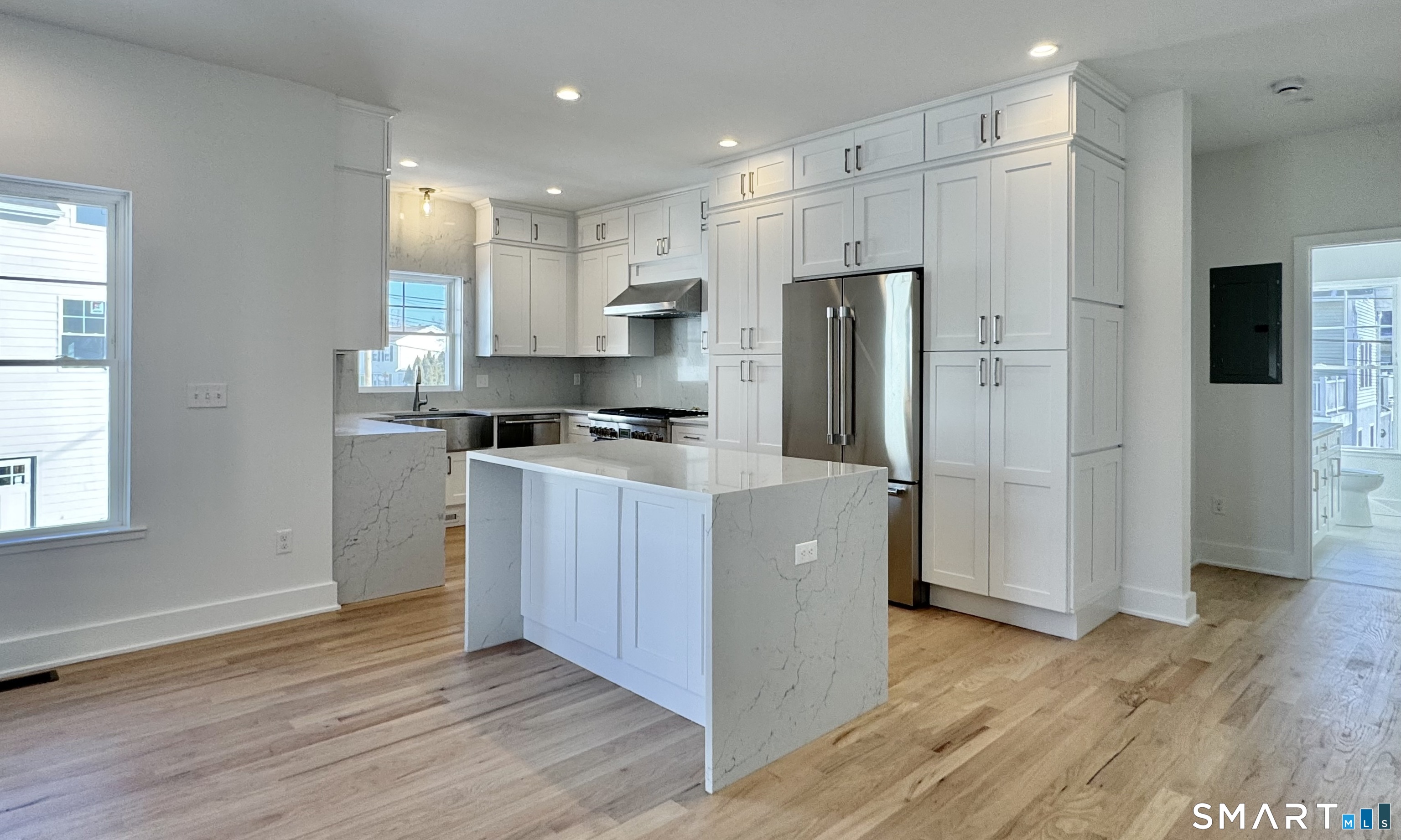 25 Village Road Milford, CT 06460 - Photo 2 of 27 a kitchen with stainless steel appliances a refrigerator and a stove top oven