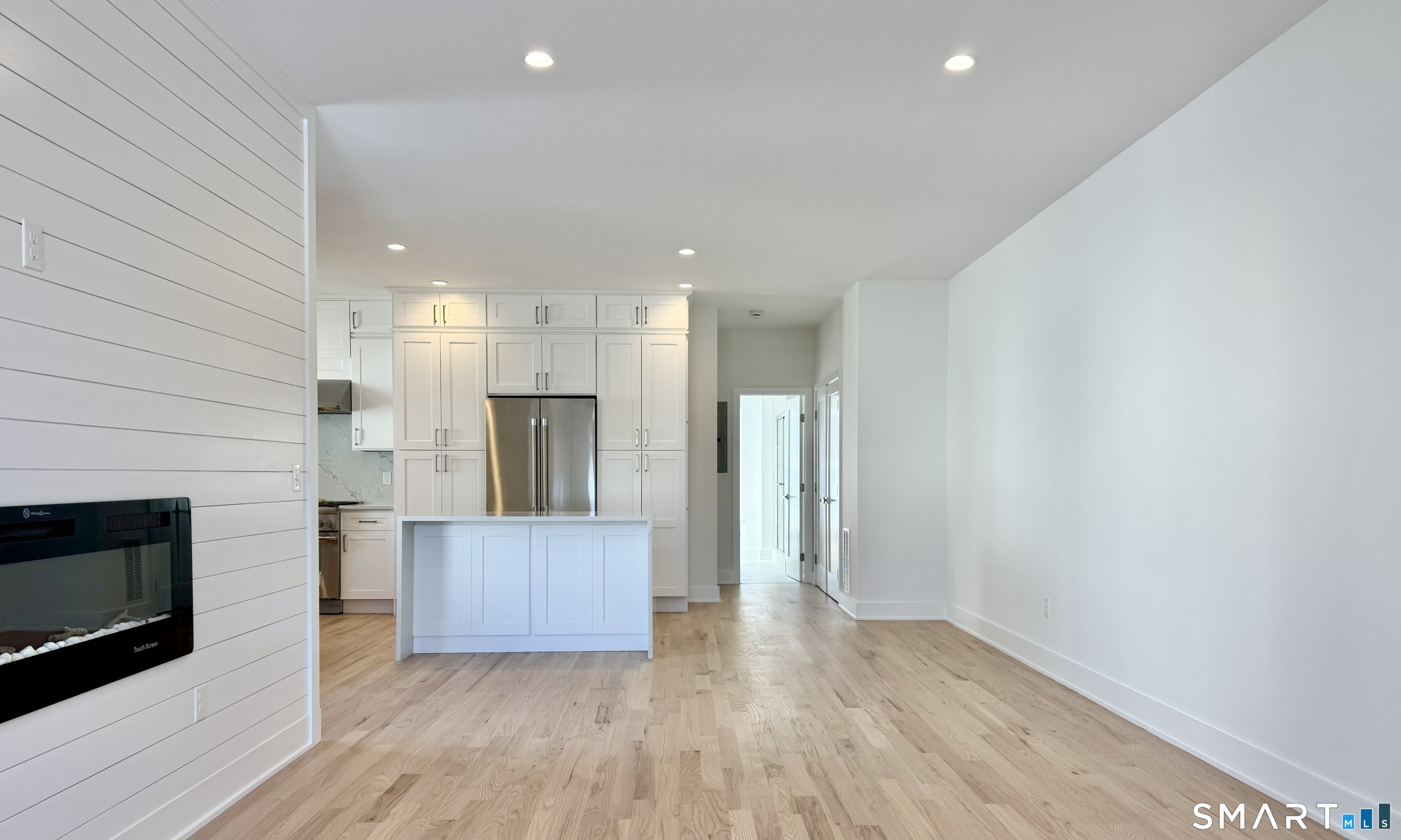 25 Village Road Milford, CT 06460 - Photo 5 of 27 a view of a kitchen with a sink and a fireplace