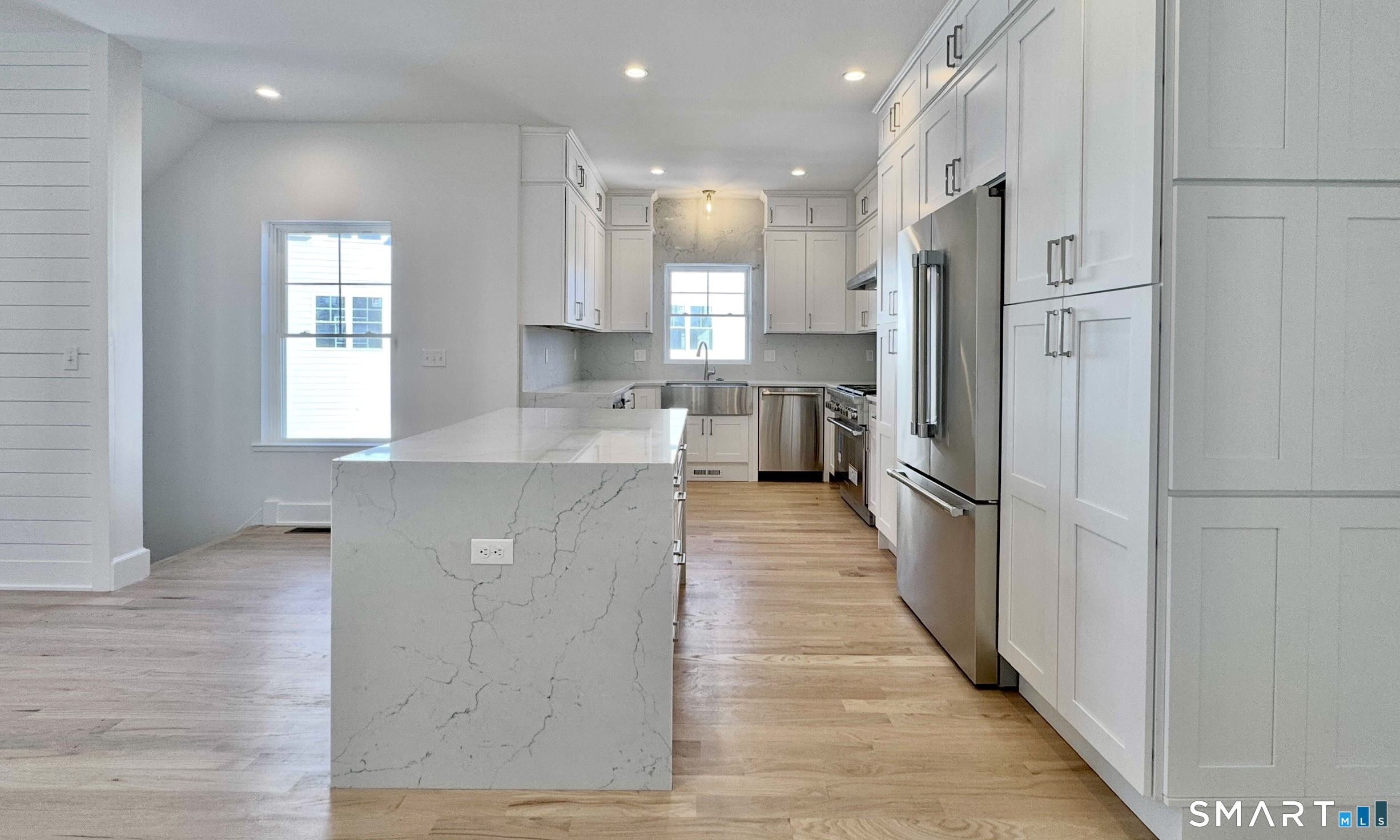 25 Village Road Milford, CT 06460 - Photo 6 of 27 a large kitchen with stainless steel appliances kitchen island granite countertop a refrigerator and a sink