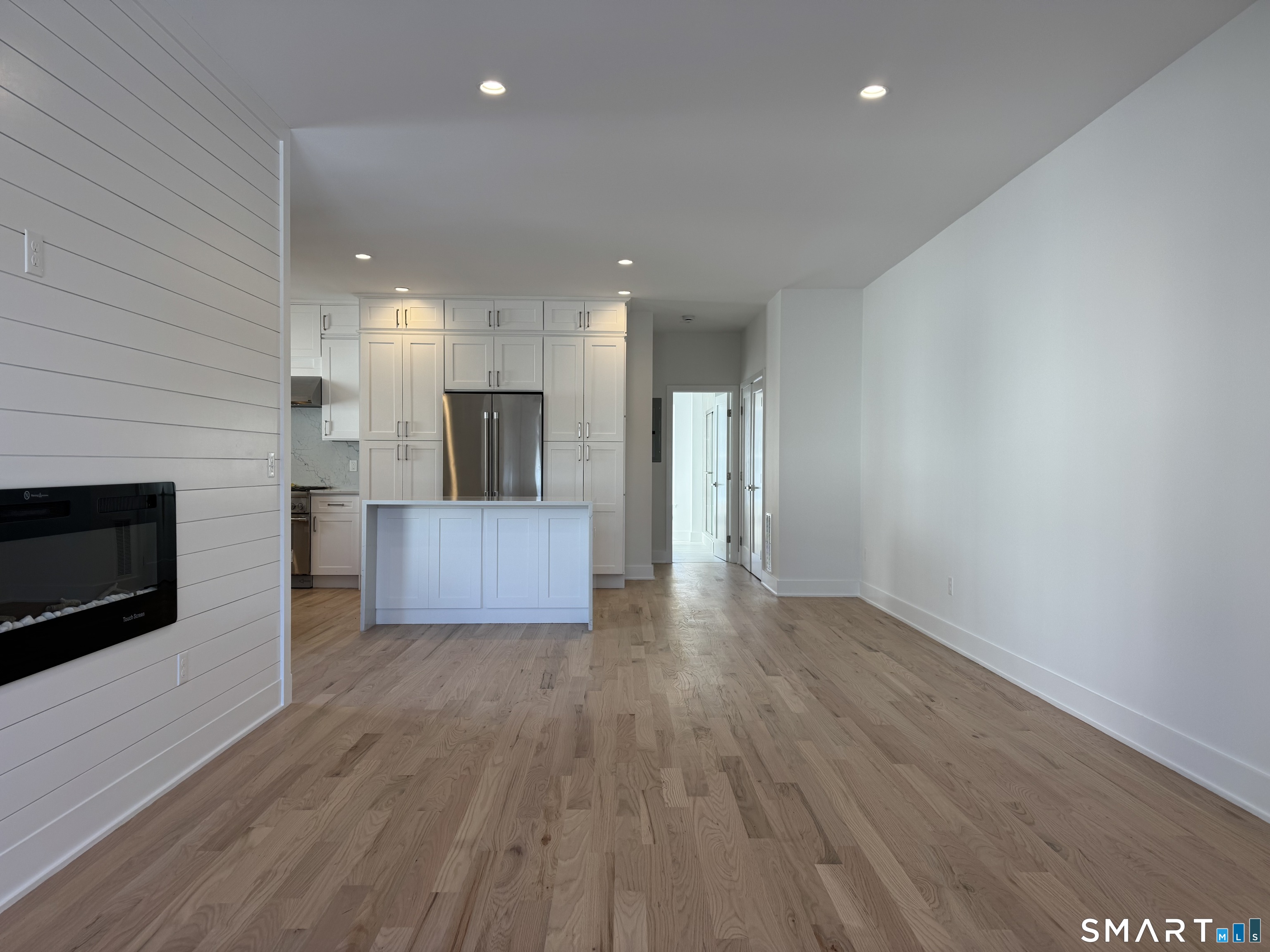 25 Village Road Milford, CT 06460 - Photo 9 of 27 a view of a kitchen with a sink and a fireplace