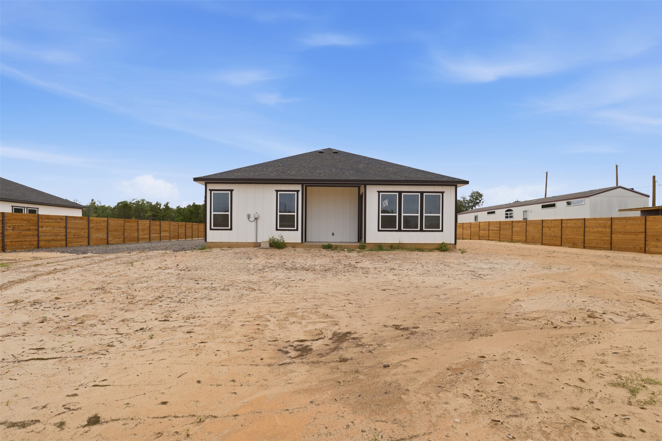 113 Los Robles Road Elgin, TX 78621 - Photo 20 of 20 Contemporary rear exterior with white siding and dark trim windows