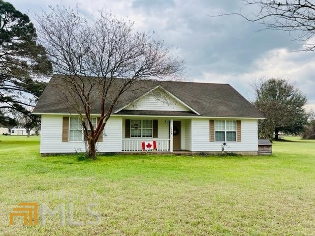 a view of a house with a yard and tree s