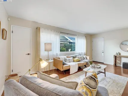 a living room with furniture and a large window