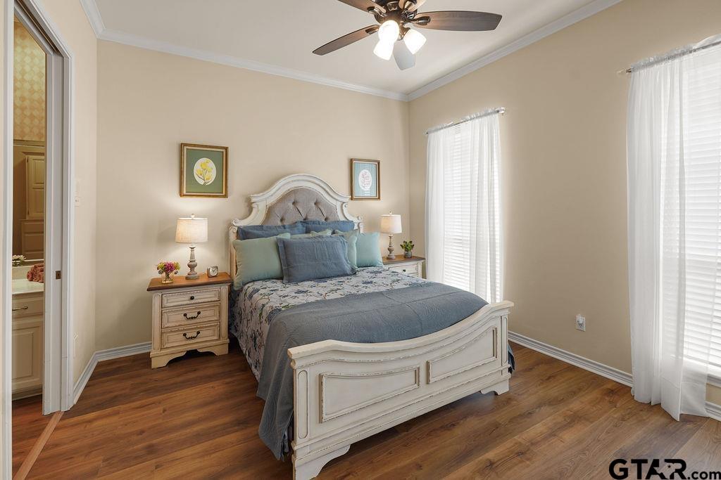 2210 Homestead Lane Tyler, TX 75701 - Photo 14 of 26 a spacious bedroom with a bed and wooden floor