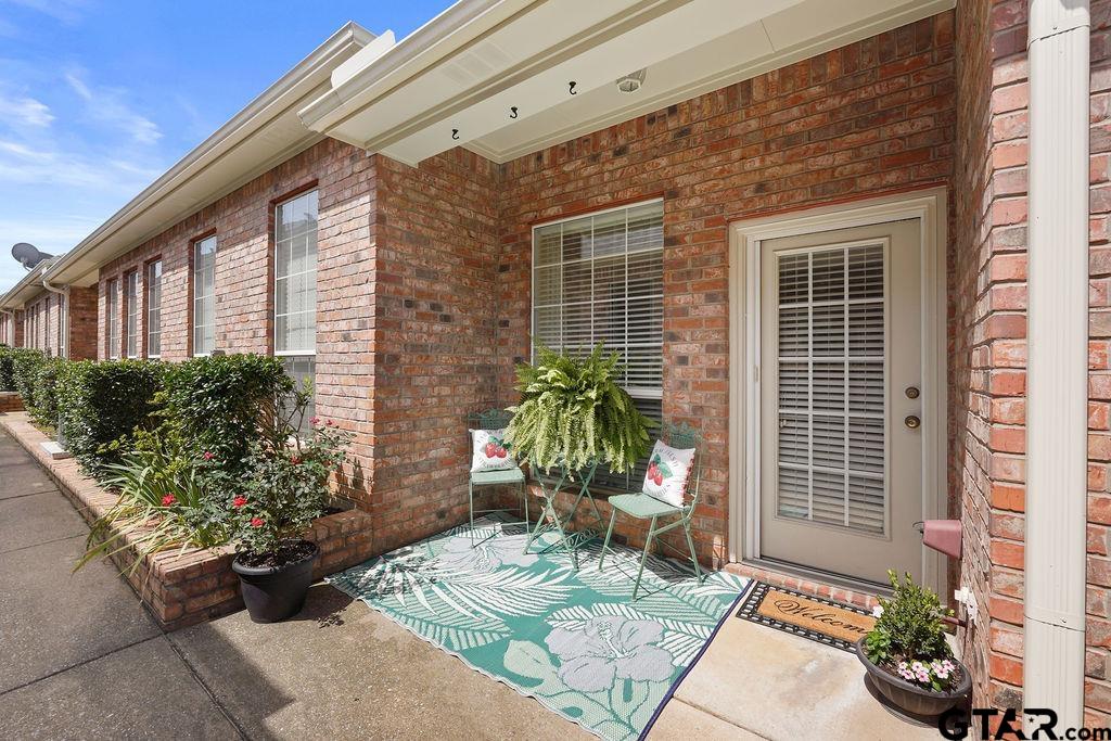 2210 Homestead Lane Tyler, TX 75701 - Photo 24 of 26 a view of a porch with chairs and potted plants