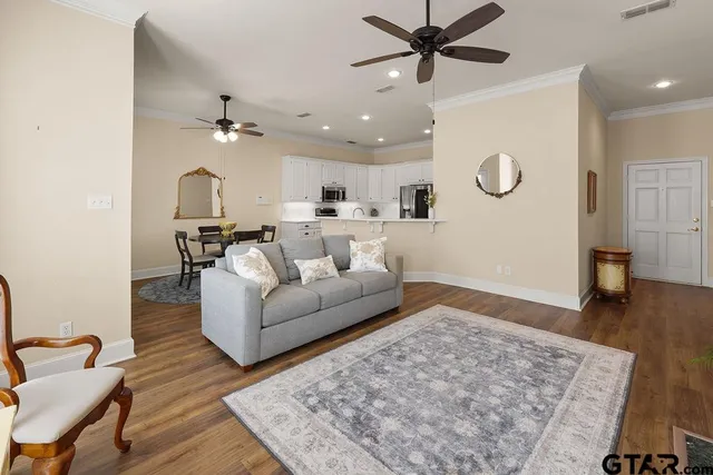 a living room with furniture and wooden floor
