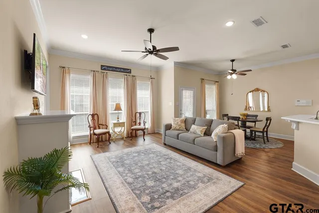 a living room with furniture and wooden floor