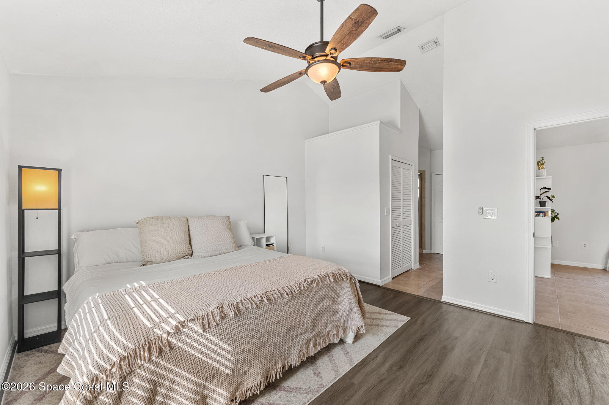 1924 Fabien Circle Melbourne, FL 32940 - Photo 16 of 35 a bedroom with a bed and a ceiling fan