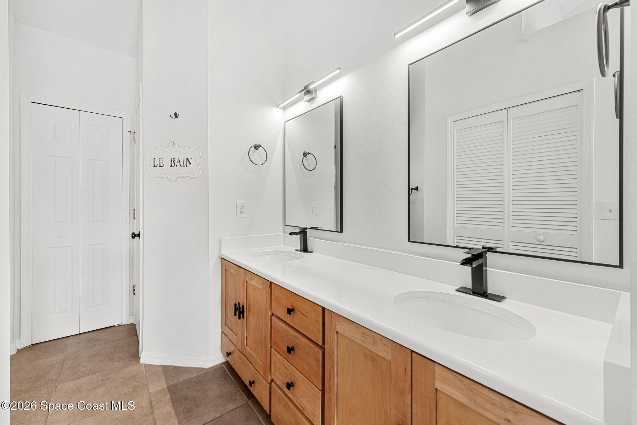 1924 Fabien Circle Melbourne, FL 32940 - Photo 18 of 35 a bathroom with a sink and a mirror