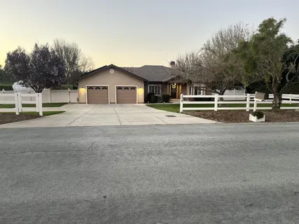 a view of house with outdoor space and sitting area