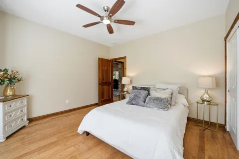 a bedroom with a bed and a potted plant