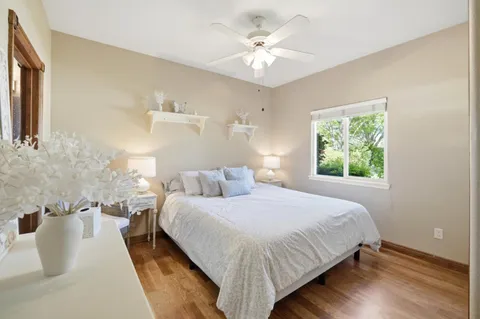a bedroom with a large bed and a chandelier
