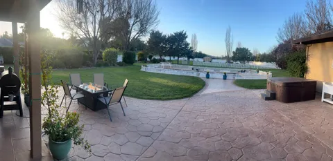 a view of a table and chairs in the garden