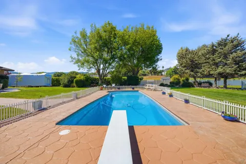 a view of swimming pool with a yard