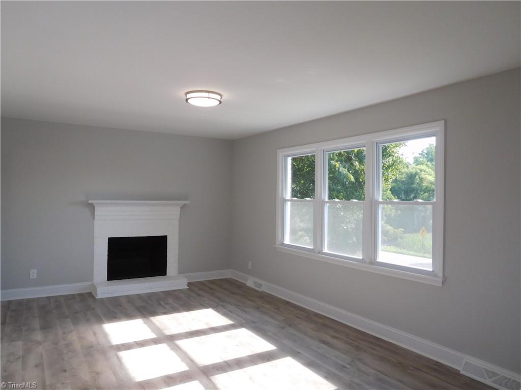 6454 Germanton Road Rural Hall, NC 27045 - Photo 3 of 28 Large Light filled Living Room w/fireplace. FP is SOLD AS IS-No Repairs will be made to any FP's or Chimney.